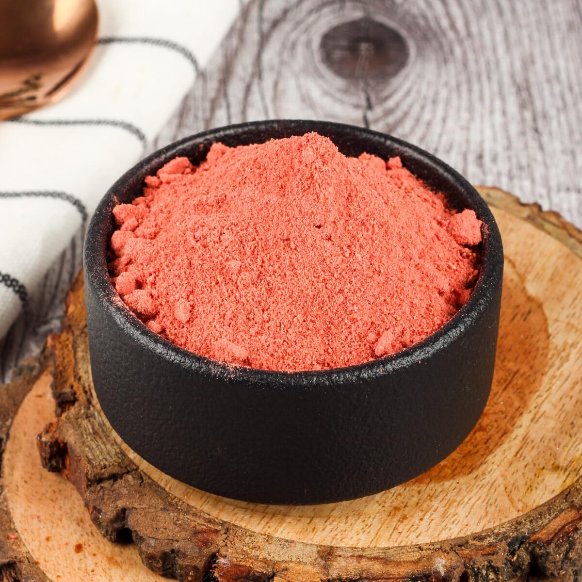 “Bright red, finely ground dehydrated strawberry powder in a bowl, showing its smooth texture and concentrated fruity flavor, ideal for smoothies, desserts, and baking.”