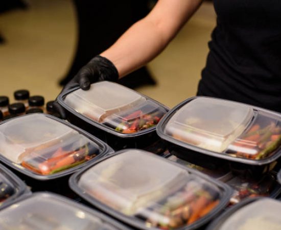 Lunch box with food in the hands. Catering